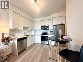 Grimsby condo for rent - A modern kitchen with a dining table and chairs.