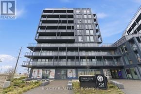 Burlington (Alton) condo for rent - A modern building with a sign that reads "BIG CITY REALTY INC. Brokerage".