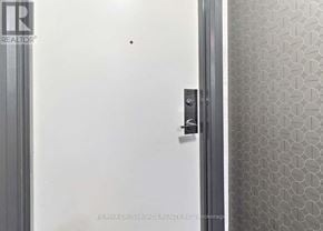 Toronto (Bendale) condo for rent - A white door with a silver handle and a small black dot on the wall.