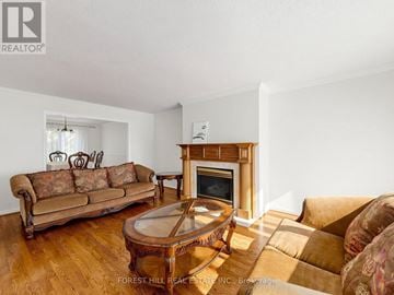 Markham (Unionville) apartment for rent - A living room with a brown couch and a fireplace.