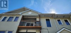 Halton Hills (Georgetown) townhouse for rent - A building with a balcony and a sign that says "REALTOR".