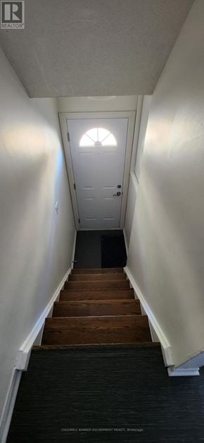 Halton Hills (Georgetown) townhouse for rent - A staircase with wooden steps and white walls.