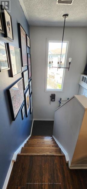 Halton Hills (Georgetown) townhouse for rent - A staircase with wooden steps and a metal railing.