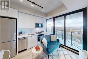 Toronto (Kensington-Chinatown) condo for rent - A modern kitchen with a blue couch and a view of the city.