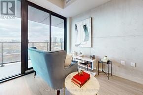 Toronto (Kensington-Chinatown) condo for rent - A room with a blue chair and a red book on a table.