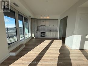 Toronto (Banbury-Don Mills) condo for rent - A sunny day in a spacious living room with a fireplace and a view of the city.
