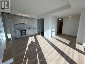 Toronto (Banbury-Don Mills) condo for rent - A spacious living room with a fireplace and a person's shadow cast on the floor.