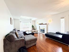 Surrey apartment for rent - A living room with a grey couch and a black couch.