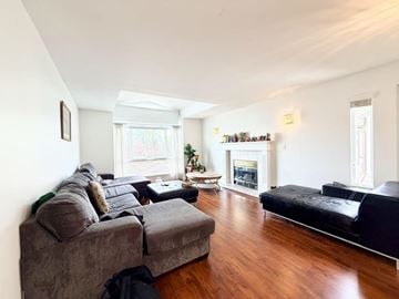 Surrey apartment for rent - A living room with a grey couch and a black couch.
