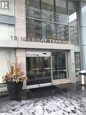 Toronto (Waterfront Communities) condo for rent - The entrance to a building with a glass door and a sign that reads "15 Iceboat Terrace".