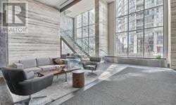 Toronto (Waterfront Communities) condo for rent - A living room with a couch, a coffee table, and a staircase.