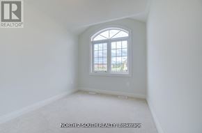 Vaughan (West Woodbridge) apartment for rent - A room with a large window and a carpeted floor.
