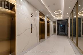 Toronto (Waterfront Communities) condo for rent - A hallway with marble floors and walls, and a number 3 on the wall.