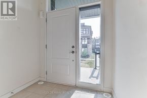 Markham (Wismer) townhouse for rent - A white door with a glass window is open to a balcony.