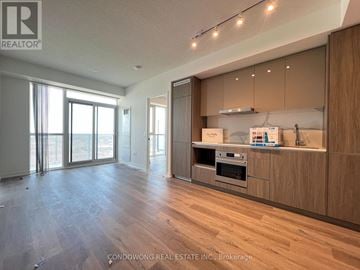 Vaughan (Vaughan Corporate Centre) condo for rent - A spacious kitchen with wooden cabinets and a stainless steel oven.