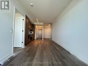Vaughan (Vaughan Corporate Centre) condo for rent - A long hallway with wood floors and white walls.