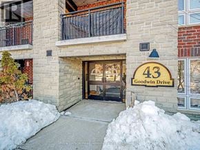 Guelph (Pineridge/Westminster Woods) condo for rent - The entrance to a building with a sign that reads "43 Goodwin Drive".