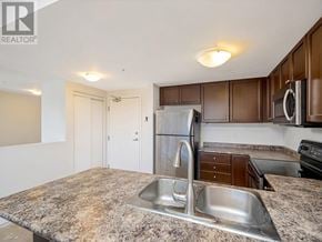 Guelph (Pineridge/Westminster Woods) condo for rent - A kitchen with a granite countertop and stainless steel appliances.
