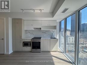 Toronto (Church-Yonge Corridor) condo for rent - A modern kitchen with a large window overlooking a cityscape.