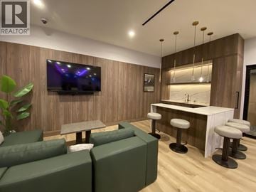 Burnaby apartment for rent - A modern living room with a green sofa set and a bar area.
