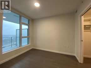 Burnaby apartment for rent - A room with a large window and a sliding door.
