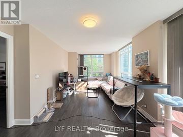Markham (Unionville) condo for rent - A living room with a white chair and a grey table.