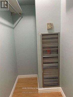 Mississauga (Cooksville) condo for rent - A room with a closed shutter and a light switch on the wall.