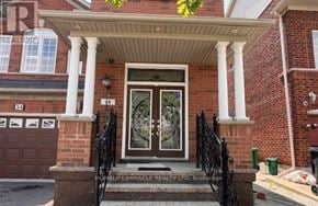 Brampton (Bram East) apartment for rent - A red brick house with a black iron railing on the front porch.