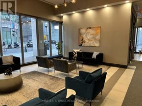 Toronto (Waterfront Communities) condo for rent - A waiting area with a sofa, chairs and a painting on the wall.