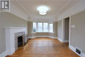 Hamilton (Delta) apartment for rent - A spacious room with a fireplace and a window.