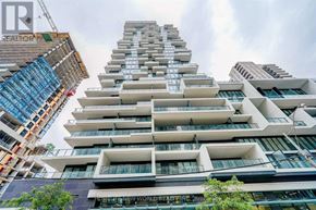 Toronto (Church-Yonge Corridor) condo for rent - A tall building with many windows is under construction.