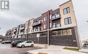 Mississauga (Erin Mills) condo for rent - A building with the Realty logo on it.
