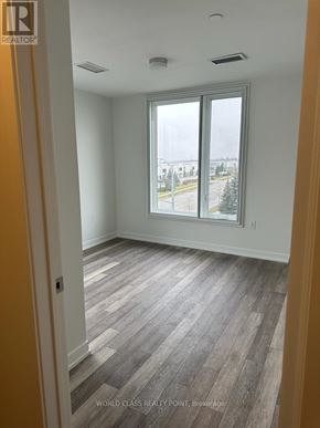 Mississauga (Erin Mills) condo for rent - A room with a window and wooden flooring.