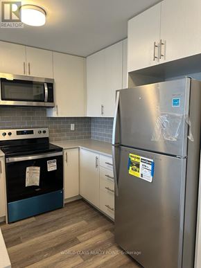 Mississauga (Erin Mills) condo for rent - A stainless steel refrigerator with a sticker on it.