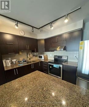 Markham (Unionville) condo for rent - A kitchen with granite countertops and dark cabinets.