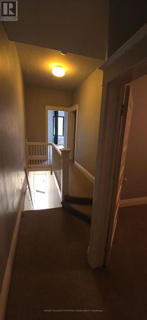 Toronto (Roncesvalles) apartment for rent - A hallway with a light on and a door at the end.