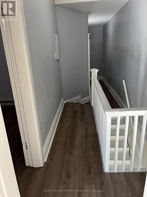 Toronto (Roncesvalles) apartment for rent - A white crib sits in a hallway with wood floors.