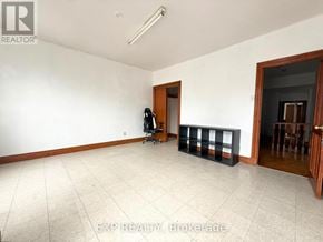 Toronto (South Riverdale) townhouse for rent - A room with white walls and a tiled floor.