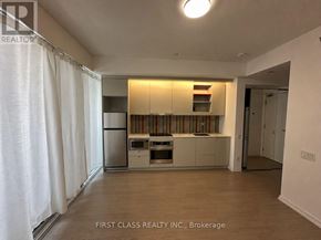 Toronto (Waterfront Communities) condo for rent - A kitchen with white cabinets and a dishwasher.