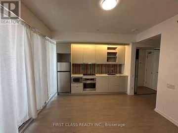 Toronto (Waterfront Communities) condo for rent - A kitchen with white cabinets and a dishwasher.