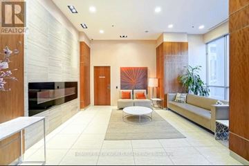 Toronto (Bendale) condo for rent - A modern living room with a wooden door and a glass wall.
