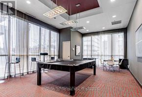 Toronto (Bendale) condo for rent - A room with a black table and chairs with a glass wall.