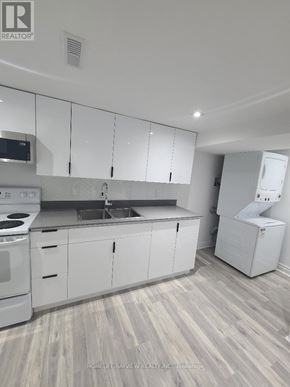 Vaughan (Brownridge) apartment for rent - A kitchen with white cabinets and a wooden floor.