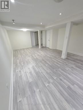 Vaughan (Brownridge) apartment for rent - A spacious room with wooden flooring and white walls.