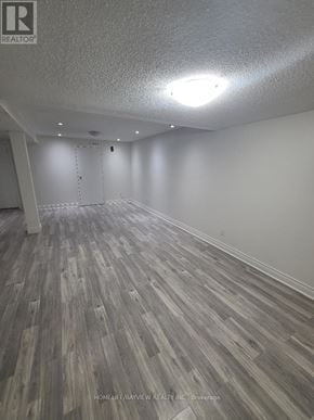 Vaughan (Brownridge) apartment for rent - A room with wooden flooring and a white ceiling.