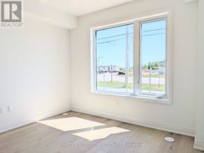 Richmond Hill townhouse for rent - A room with a large window and a view of the street outside.