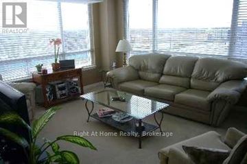 Toronto (Bayview Village) condo for rent - A living room with a couch, coffee table, and a window with blinds.