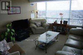 Toronto (Bayview Village) condo for rent - A living room with a couch, chair, and television.