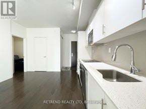 Toronto (Moss Park) condo for rent - A kitchen with white cabinets and a sink.
