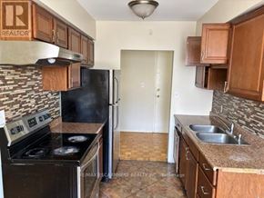 Hamilton (Glenview) multi-family for rent - A kitchen with a stove, sink, and cabinets.